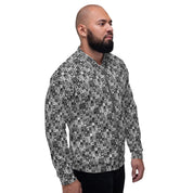 A front and side view of a bearded man wearing a cool, monotone patterned bomber jacket in a modern squares print in black, white and gray.